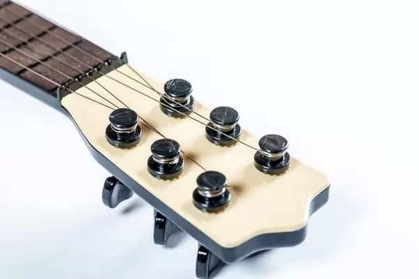 The neck of the guitar with strained strings  Flip 2019