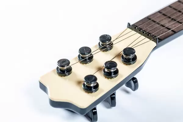 The neck of the guitar with strained strings