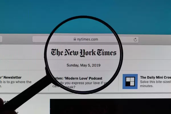 The New York TImes logo under magnifying glass