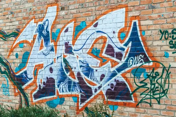 The old wall, painted in color graffiti drawing blue aerosol paints, street art