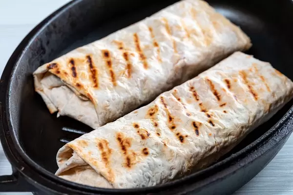 The pita bread with the filling in the pan (Flip 2019)