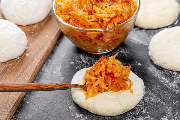 The process of cooking homemade pies with cabbage