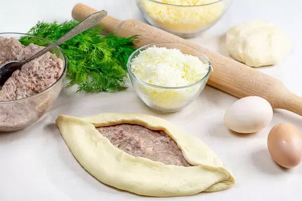 The process of making Adjarian khachapuri with raw ingredients
