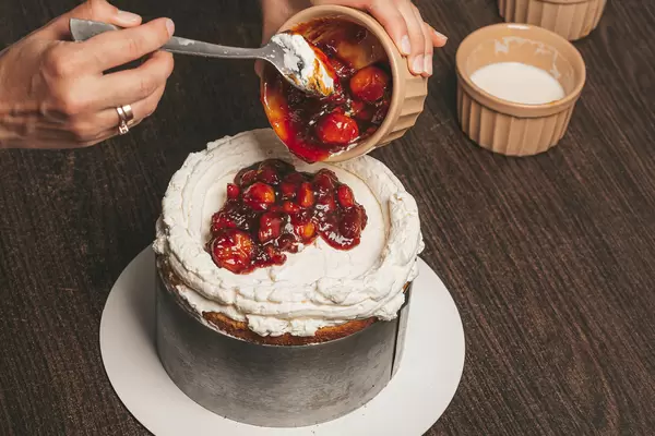 The process of making homemade cake with cream and fruit
