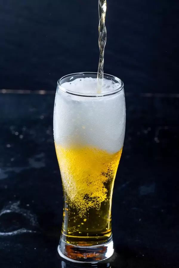 The process of pouring beer into a glass