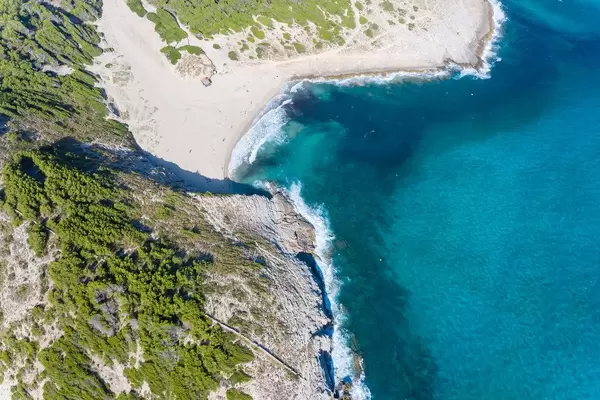 The sandy beach of Cala Torta with turquoise water near Artà in Mallorca. Drone photo