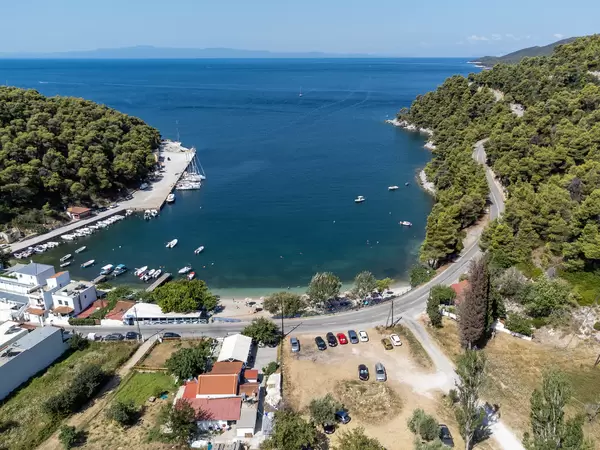 The small beach village of Agnontas on Skopelos with its port. Aerial view