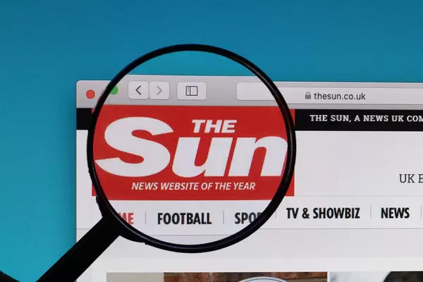 The Sun logo under magnifying glass