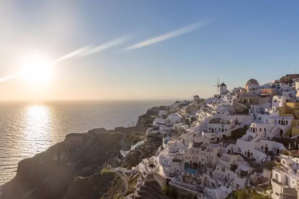 The sunset on the Aegean Sea and the picturesque village of Oia on the Greek island of Santorini