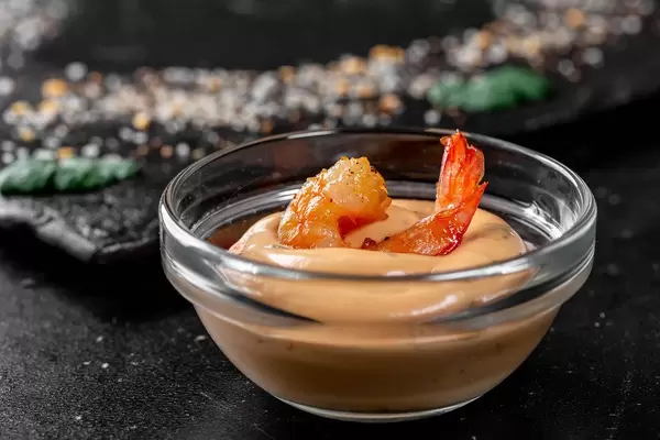 The tail of the shrimp in the sauce closeup