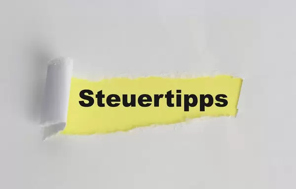 The text Steuertipps appearing behind torn white paper