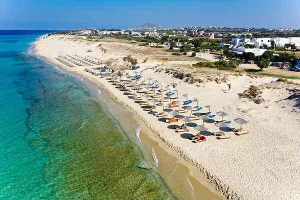 The very clean and tidy Plaka beach on Naxos with rows of thatched parasols and crystal-clear waters