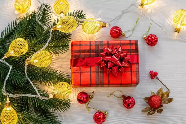 The view from the top Christmas gift in red box with glowing lights on a white background