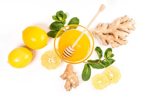 The view from the top, ginger root, mint leaves, lemons and honey on white