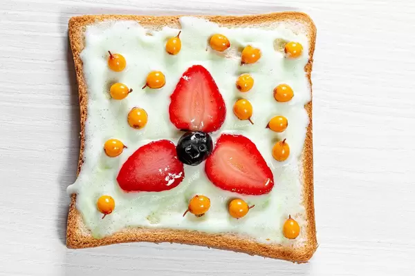 The view from the top of the sandwich with sea-buckthorn berries, blueberries and strawberries