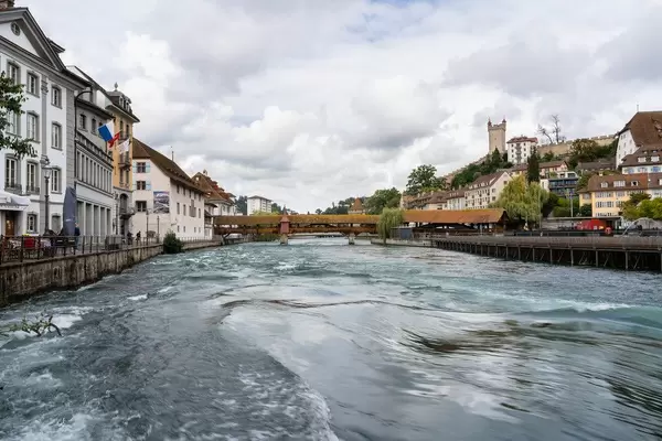 The view of a famous Chapel Bridge with castle in the background