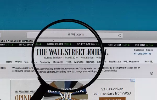 The Wall Street Journal logo under magnifying glass