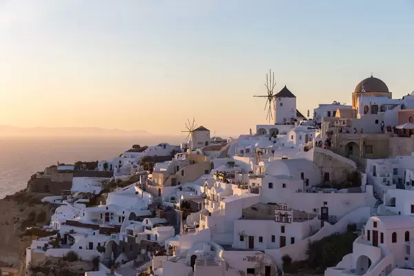 The white houses and windmills of Oia, Santorini, in the sunset light