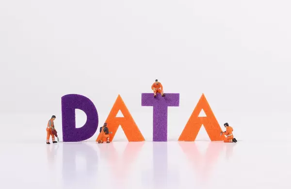The word Data with tiny workers on white background