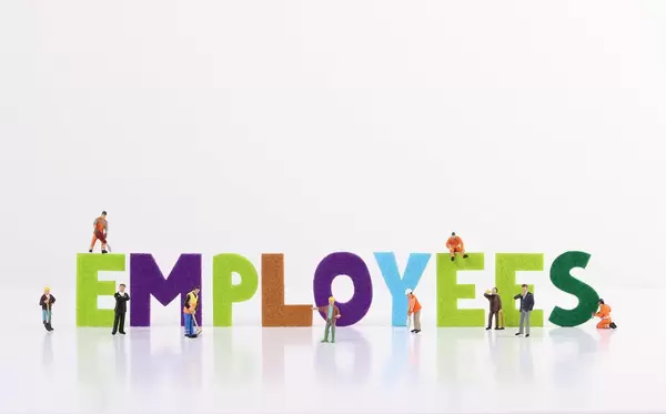 The word Employess with tiny workers on white background