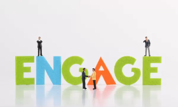 The word Engage with group of businessman on white background