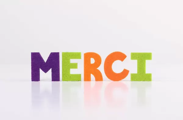 The word Merci on white background