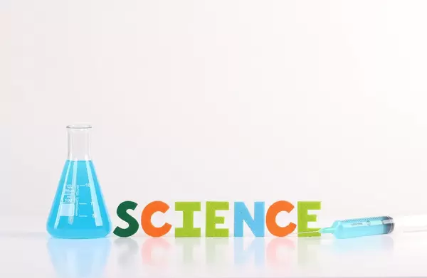 The word Science with laboratory flask and syringe on white background