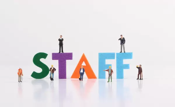 The word Staff with construction workers and two businessman on white background