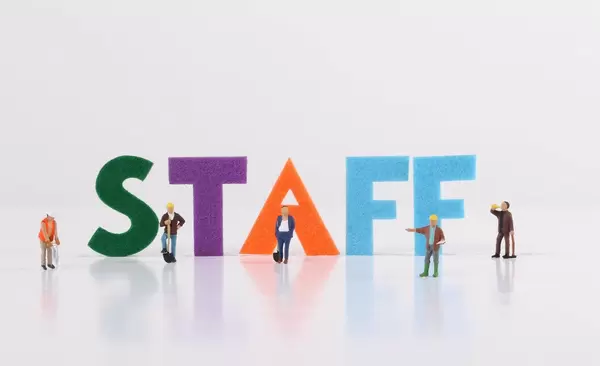 The word Staff with construction workers on white background