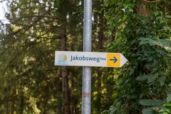 The yellow arrow, the sign of the Camino de Santiago, pointing to the right, direction Tyrol