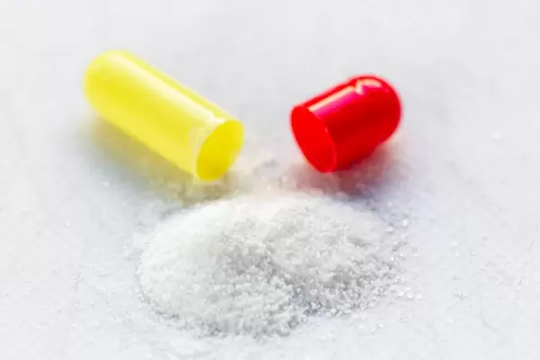 Therapeutic powder from an open capsule behind