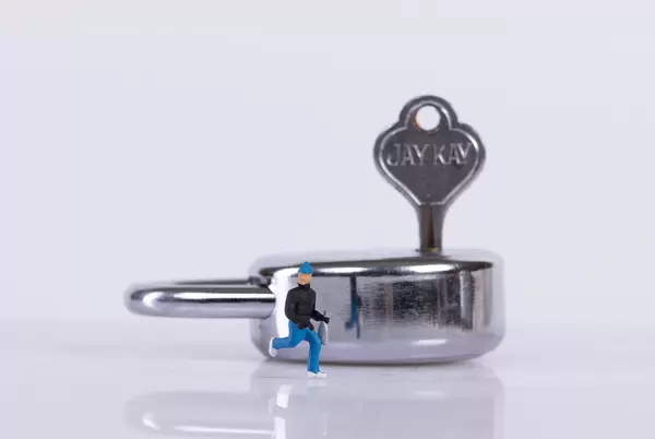 Thief and padlock on white background