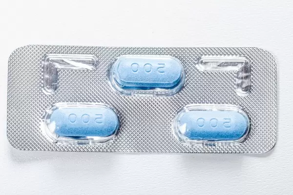 Three blue antibiotic pills in a pack. View from above (Flip 2019)