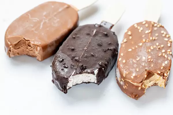 Three chocolate ice creams on white background