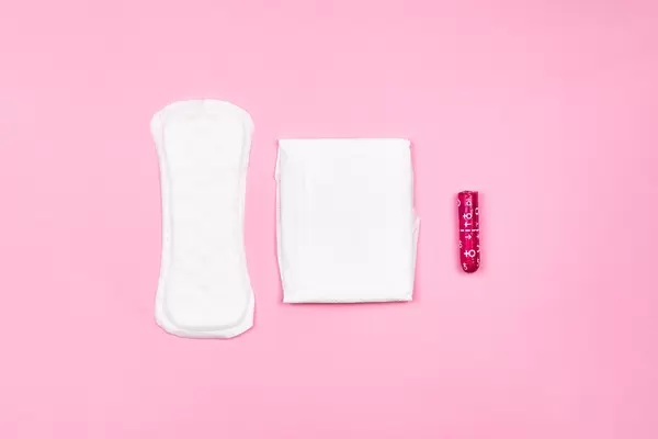 Three different types of feminine hygiene products on pink background