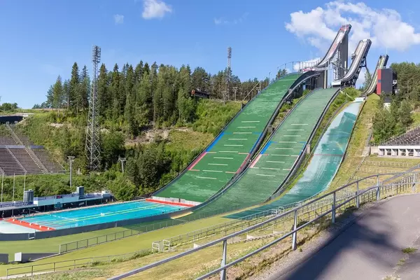 Three empty ski jumps in the ski jumping facility for skiers, near the sports centre during summer season in Lahti, Finland