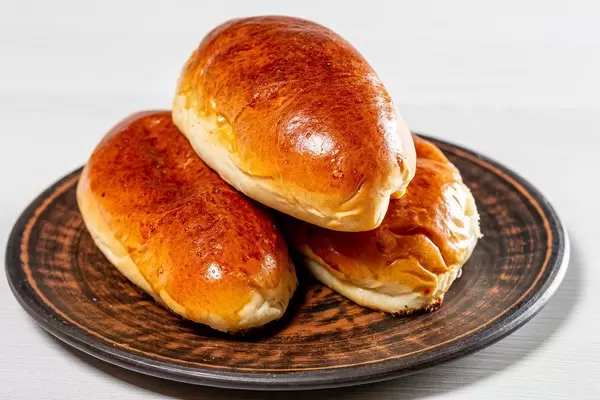 Three fresh baked pies on a brown plate (Flip 2019)