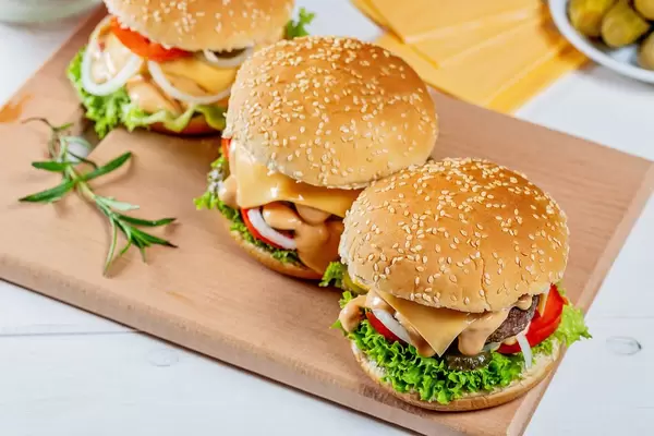 Three hamburgers on the kitchen Board