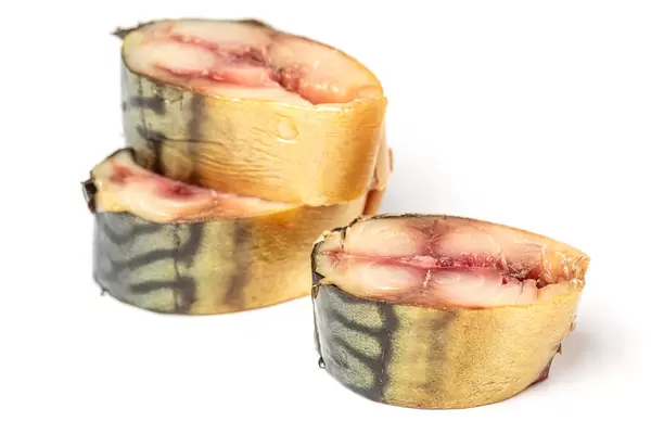 Three pieces of smoked mackerel fish on a white background