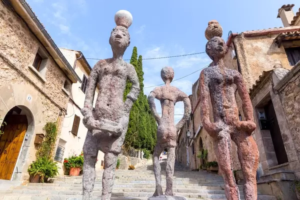 Three sculptures of human figures on the 365 steps in Pollença. "Raons Humanes" by Joan Bennàssar
