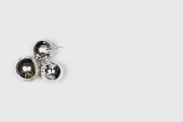 Three silver Christmas toys on the white background