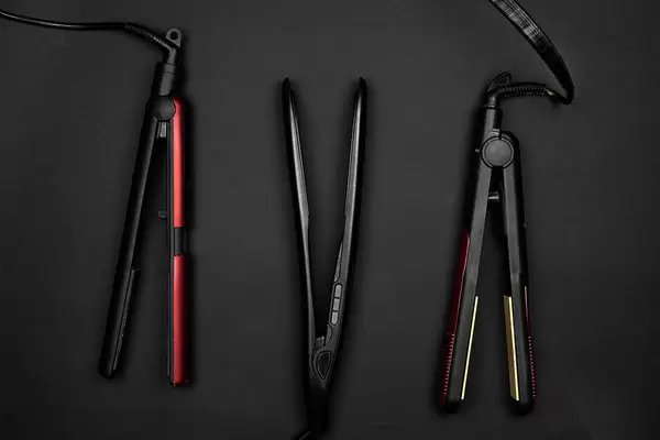 Three types of hair straightener on dark surface