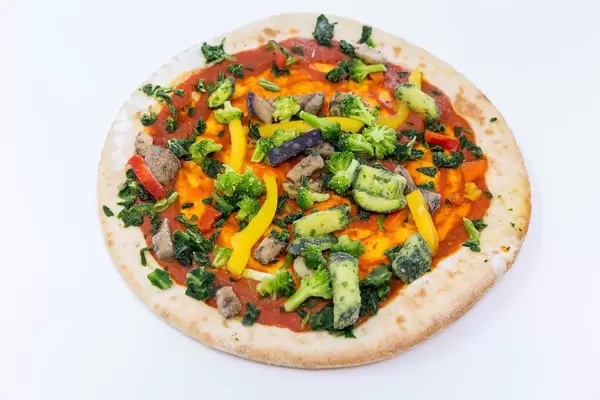 Tiefgefrorene vegane Pizza mit Gemüse-Belag im italienischen Stil vor weißem Hintergrund