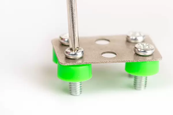 Tightening a screw with a screwdriver, close-up