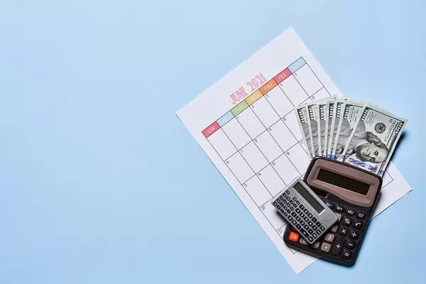 Time to pay the bills. US dollars and monthly calendar