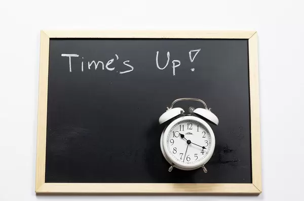 Time's up written on a black chalkboard