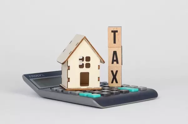 Tiny house and Tax text on calculator