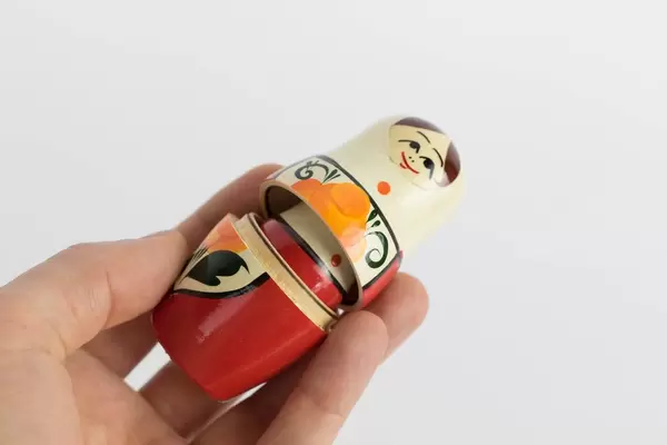 Tiny Russian doll in mans hand