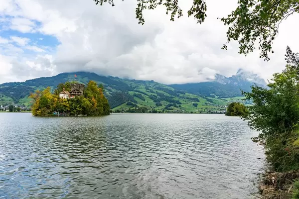 Tiny Schwanau island in the Swiss lake with a house on it