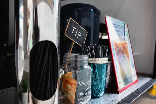Tip jar alongside condiments